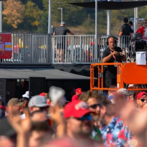 KC tailgate camera operator on lift over crowd